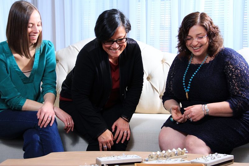 Couple shopping for an engagement ring during a custom jewelry consultation